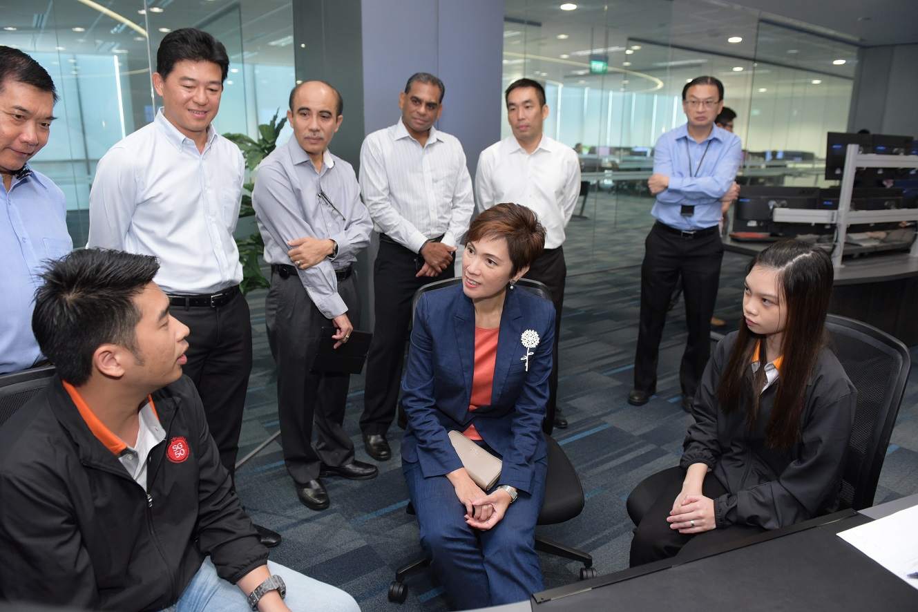 SMS Josephine Teo at PSA with SkillsFuture Trainee, Pei Jun and her OJT mentor, Kelvin