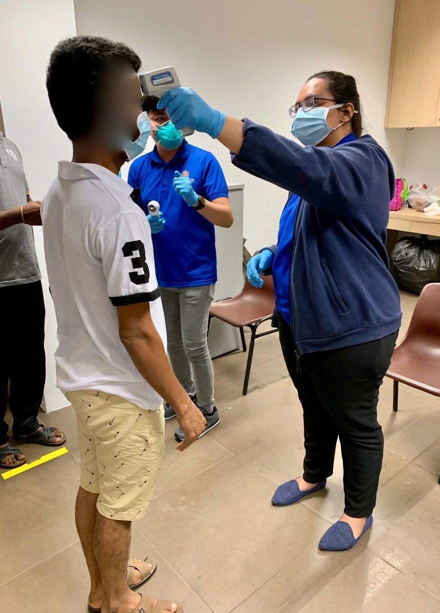 Workers+undergoing+health+screening