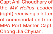 Capt Anil Choudhary of the MV Helios Leader (right) receiving a letter of commendation from MPA Port Master Capt. Cho...