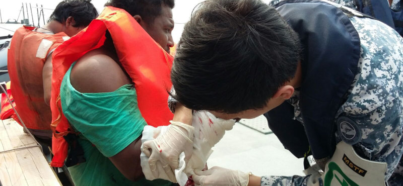 RSS Independence crew providing medical aid tothe fishermen