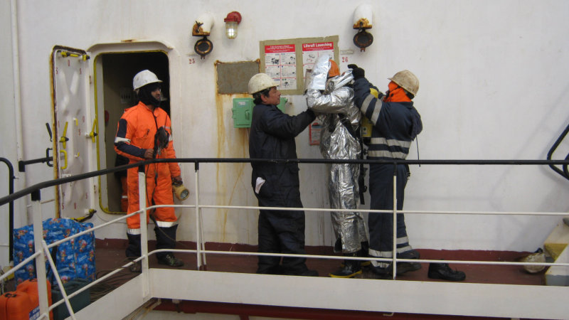 Crew dons fire-fighting equipment